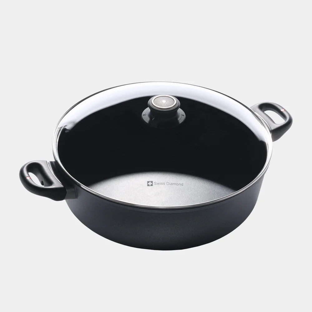 Scopri la qualità svizzera nel nostro tegame da 28 cm perfetta per arrosti, gulasch e altro. Realizzata in alluminio fuso riciclato al 100% per una distribuzione uniforme del calore. Resistente al forno fino a 500°F, passa senza problemi dal piano cottura alla tavola. Scopri la nostra Collezione Induzione per la versione a induzione.